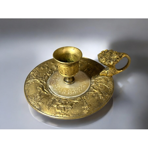 613 - A French Gilt bronze & Mother-of-Pearl Chamberstick.Late 18th / 19th century.Embossed 'Hunt' sce... 