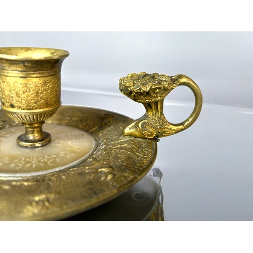 613 - A French Gilt bronze & Mother-of-Pearl Chamberstick.Late 18th / 19th century.Embossed 'Hunt' sce... 