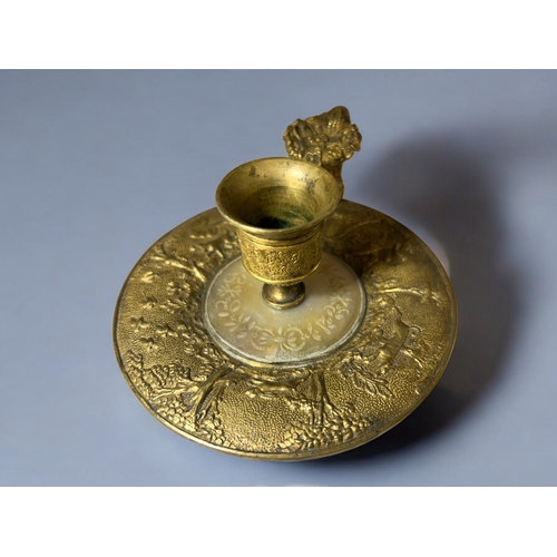 613 - A French Gilt bronze & Mother-of-Pearl Chamberstick.Late 18th / 19th century.Embossed 'Hunt' sce... 