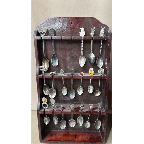 109 - A collection of vintage souvenir spoons with intricate decorative finials, housed in four wooden dis... 