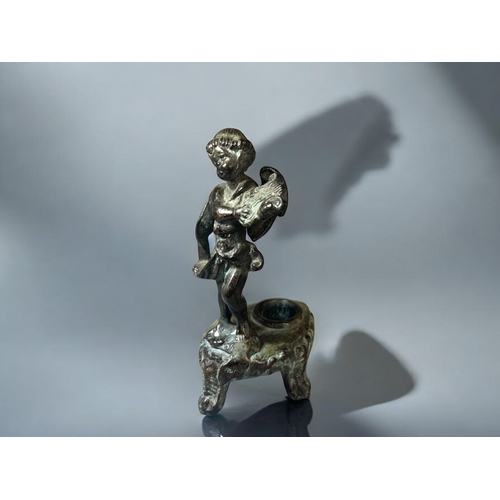 616 - A 19th century Grand Tour Verdigris bronze candlestick.Depicting a winged Putto playing a lyre. Heig... 