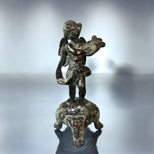 616 - A 19th century Grand Tour Verdigris bronze candlestick.Depicting a winged Putto playing a lyre. Heig... 