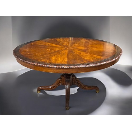 348 - A fine, large Mahogany centre table.Sunburst design top with inlaid stylised scrolling border. Acant... 