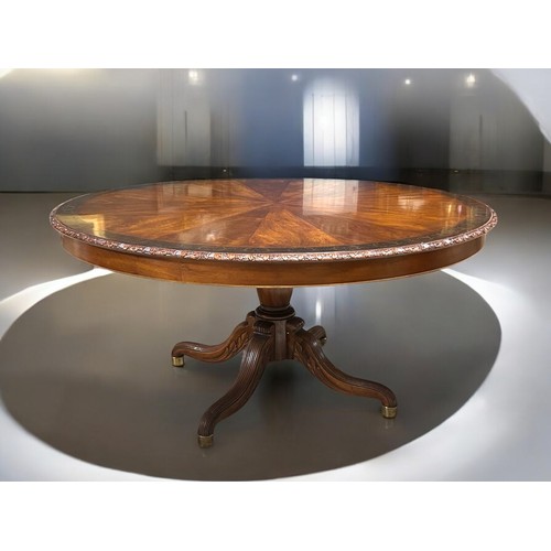 348 - A fine, large Mahogany centre table.Sunburst design top with inlaid stylised scrolling border. Acant... 