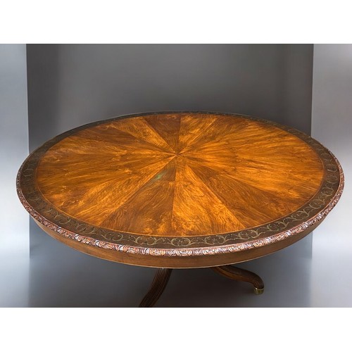 348 - A fine, large Mahogany centre table.Sunburst design top with inlaid stylised scrolling border. Acant... 