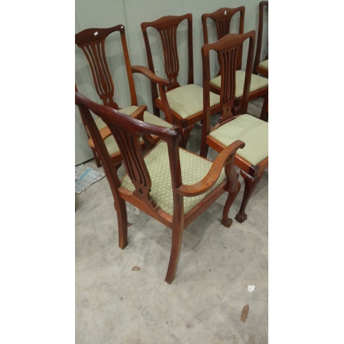 127 - Set of six mahogany dining chairs feature Chippendale-style backs and upholstered seats. They have c... 