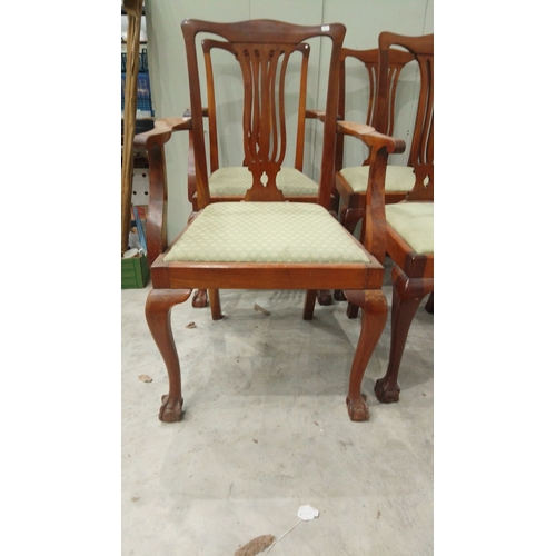 127 - Set of six mahogany dining chairs feature Chippendale-style backs and upholstered seats. They have c... 