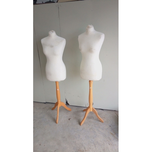 132 - Pair of vintage dress forms on wooden tripod bases with Bone fabric and adjustable stands.