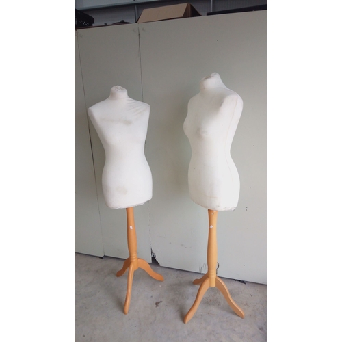 132 - Pair of vintage dress forms on wooden tripod bases with Bone fabric and adjustable stands.