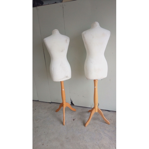 132 - Pair of vintage dress forms on wooden tripod bases with Bone fabric and adjustable stands.