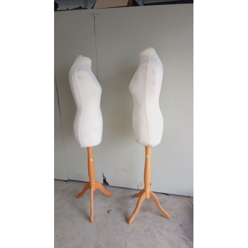 132 - Pair of vintage dress forms on wooden tripod bases with Bone fabric and adjustable stands.