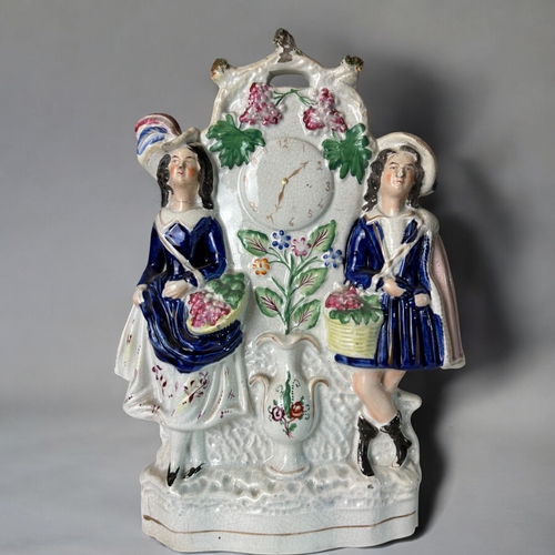 132 - Two large 19th century Staffordshire flatback clock face figures. Fruit sellers.Tallest Height - 33c... 