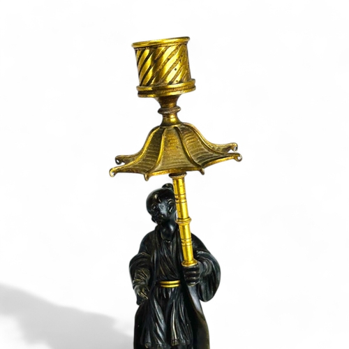 330 - A Charles X Gilt and Patinated bronze Chinoiserie candlestick. French, 1st quarter 19th century. Hei... 