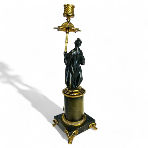 330 - A Charles X Gilt and Patinated bronze Chinoiserie candlestick. French, 1st quarter 19th century. Hei... 