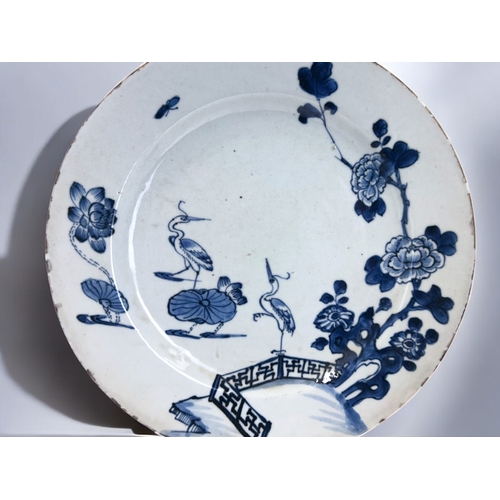 34 - A Chinese porcelain charger. Qing dynasty, Qianlong period. Decorated with Cranes & lilies, bord... 