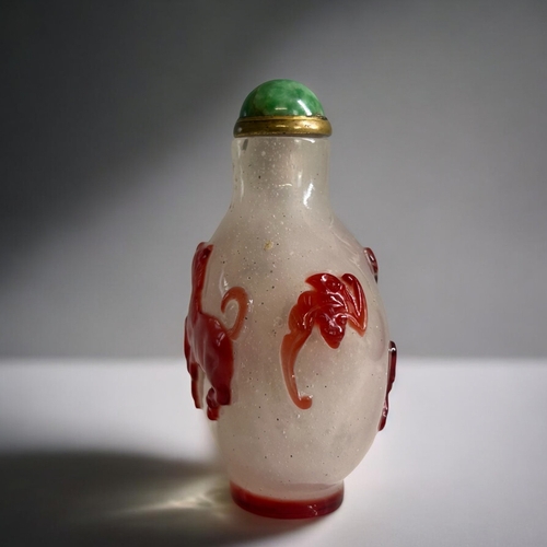 60C - Chinese Red glass overlay on bubble suffused ground Snuff Bottle.  Red glass depicting a horse to bo... 