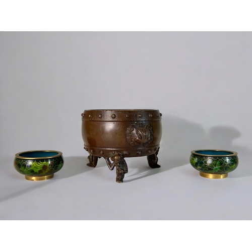 10 - A Chinese bronze censer.Raised on 'Monkey' legs and Taotie mask handles. Together with a pair of Chi... 