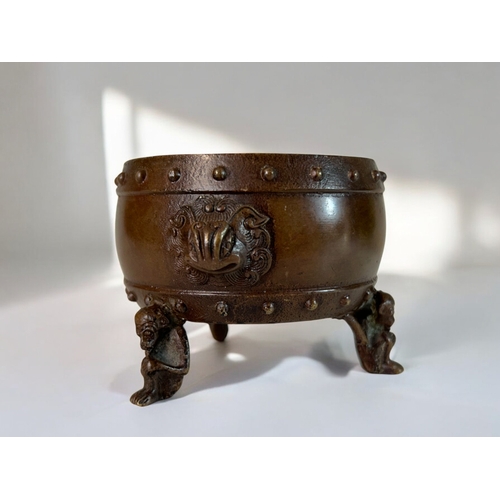 10 - A Chinese bronze censer.Raised on 'Monkey' legs and Taotie mask handles. Together with a pair of Chi... 