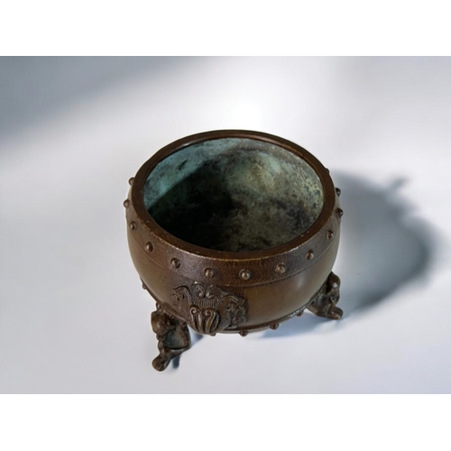 10 - A Chinese bronze censer.Raised on 'Monkey' legs and Taotie mask handles. Together with a pair of Chi... 