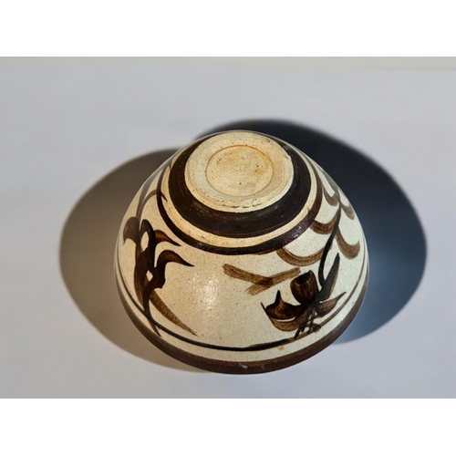 19 - A Chinese Cizhou ware bowl.20th century. Exterior painted in foliate design, with petal design to in... 