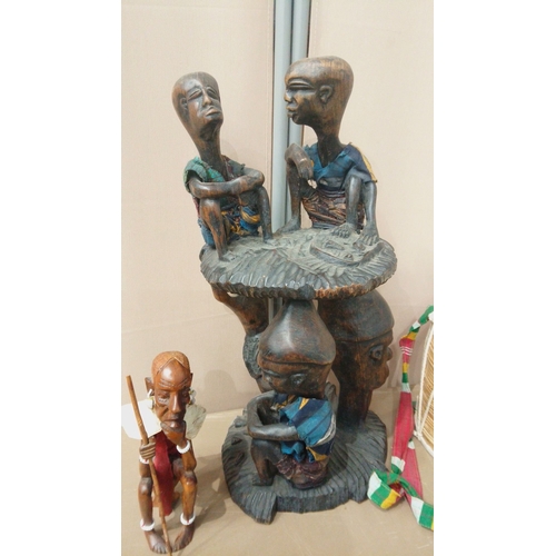 3 - Mixed lot featuring hand-carved tribal wood sculptures, ceremonial drum with colorful strap, and fig... 