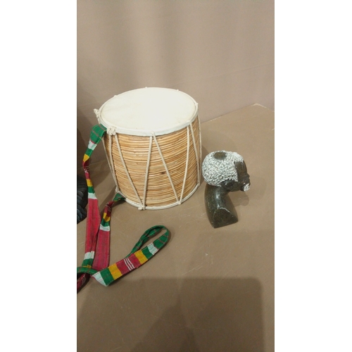 3 - Mixed lot featuring hand-carved tribal wood sculptures, ceremonial drum with colorful strap, and fig... 