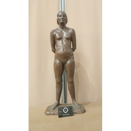 5 - Bronzed statuette of a standing nude female figure, late 20th century. Mounted on an integral base.