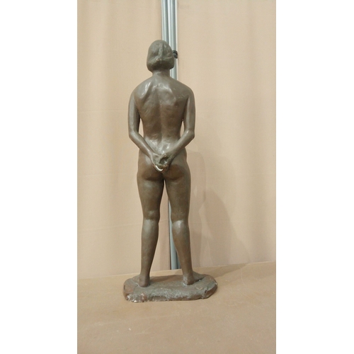 5 - Bronzed statuette of a standing nude female figure, late 20th century. Mounted on an integral base.