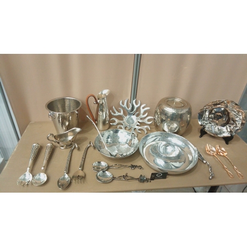 6 - Silver-plated tableware collection featuring embossed servers, hammered bowls, decorative spoons, an... 