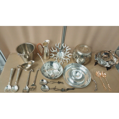 6 - Silver-plated tableware collection featuring embossed servers, hammered bowls, decorative spoons, an... 