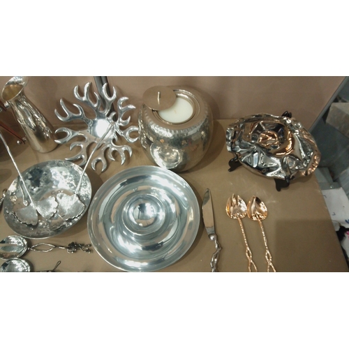 6 - Silver-plated tableware collection featuring embossed servers, hammered bowls, decorative spoons, an... 