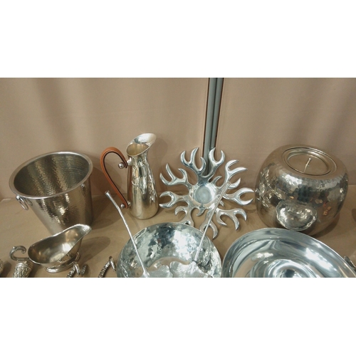 6 - Silver-plated tableware collection featuring embossed servers, hammered bowls, decorative spoons, an... 