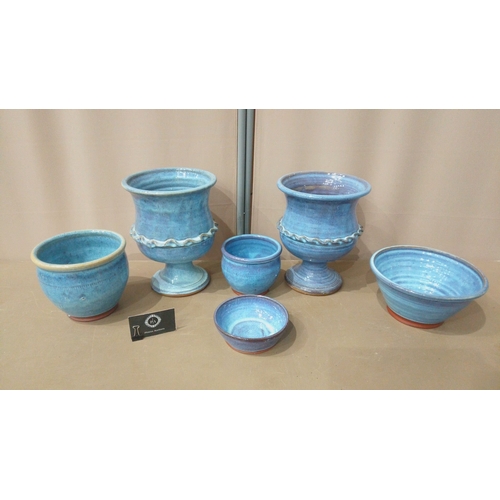 9 - Set of seven blue-glazed ceramic planters and bowls, featuring diverse shapes and intricate detailin... 