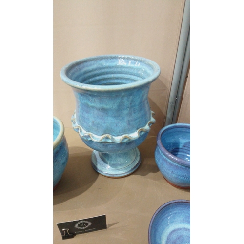 9 - Set of seven blue-glazed ceramic planters and bowls, featuring diverse shapes and intricate detailin... 