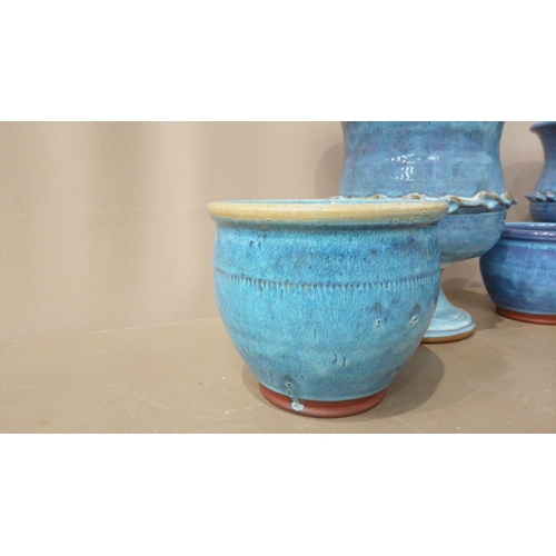 9 - Set of seven blue-glazed ceramic planters and bowls, featuring diverse shapes and intricate detailin... 