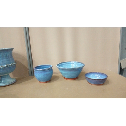 9 - Set of seven blue-glazed ceramic planters and bowls, featuring diverse shapes and intricate detailin... 