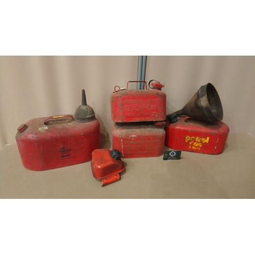 15 - Includes multiple red metal petrol cans, 