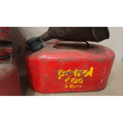 15 - Includes multiple red metal petrol cans, 