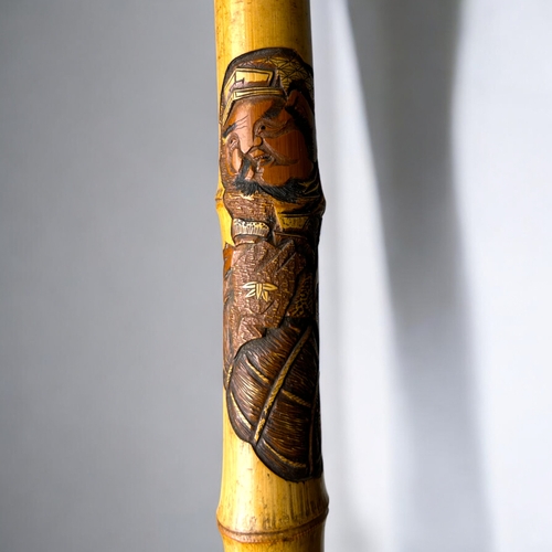 15 - A Japanese carved Bamboo walking stick.Meiji period, C 1900.Depicting Hotei on his sack, Rats and la... 