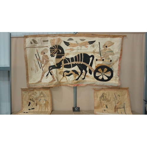 56 - Set of Egyptian-themed textile wall hangings featuring hieroglyphic motifs, chariots, and figures. L... 