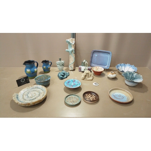 53 - Eclectic pottery collection featuring hand-painted pitchers, decorative plates, sculptural accents, ... 