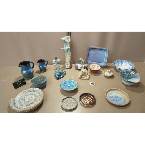 53 - Eclectic pottery collection featuring hand-painted pitchers, decorative plates, sculptural accents, ... 