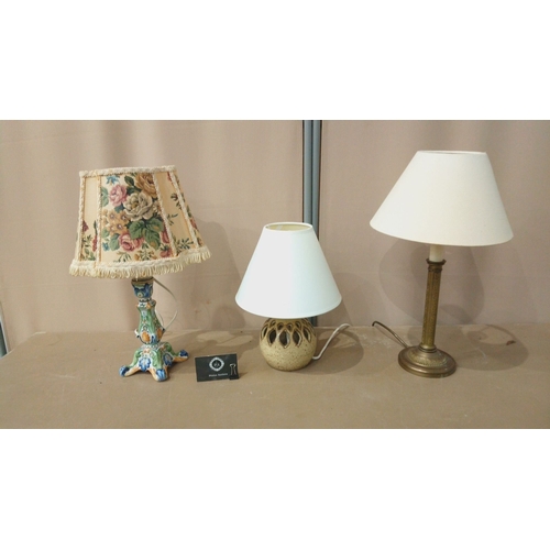 31 - Includes a brass column lamp with a cream shade, a ceramic lamp with a pierced base, and a floral-th... 