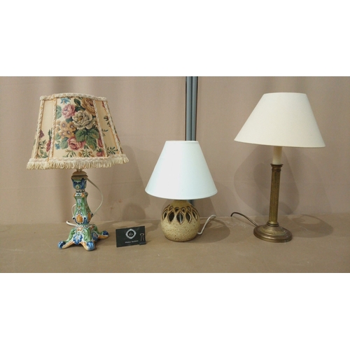 31 - Includes a brass column lamp with a cream shade, a ceramic lamp with a pierced base, and a floral-th... 