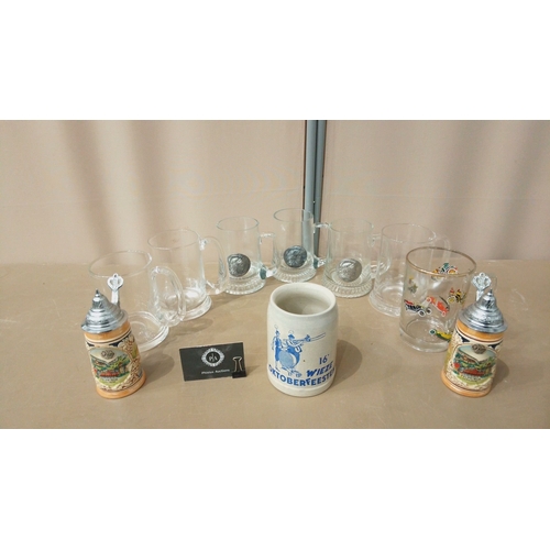 34 - Set of German-themed beer steins and mugs, featuring glass, ceramic, and pewter designs. Includes Ok... 