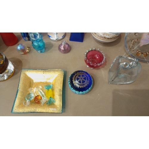 38 - Glassware collection features vibrant art glass vases, decorative bowls, silver accents, and colorfu... 