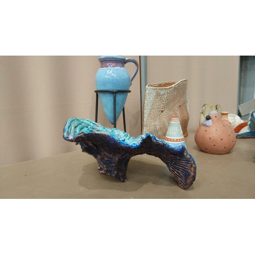 39 - Eclectic pottery collection features ceramic vessels, decorative figurines, and abstract forms. Vari... 