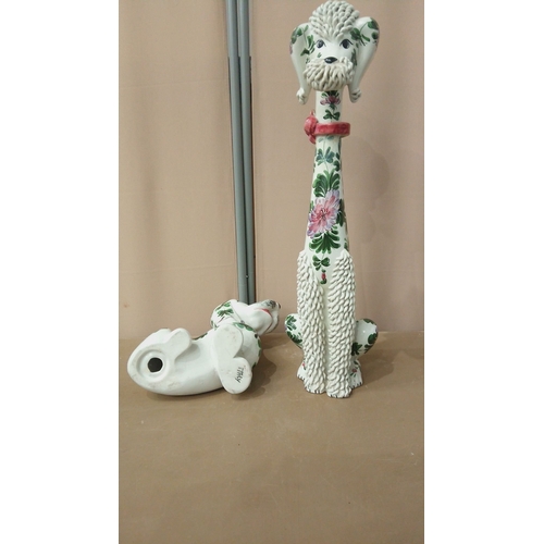 42 - Pair of ceramic dog figurines, hand-painted with floral motifs. Featuring intricate textures and vib... 