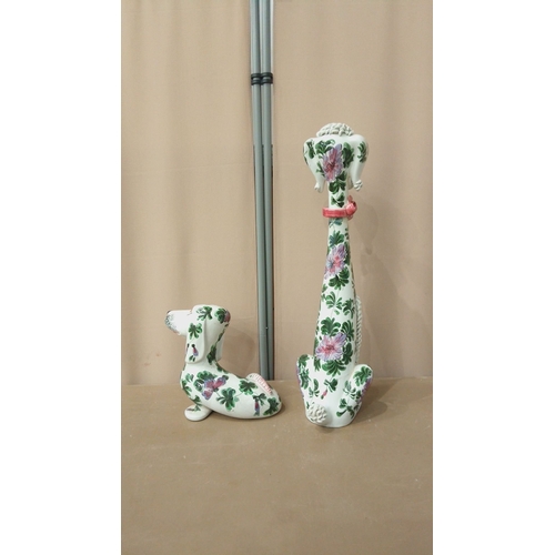 42 - Pair of ceramic dog figurines, hand-painted with floral motifs. Featuring intricate textures and vib... 