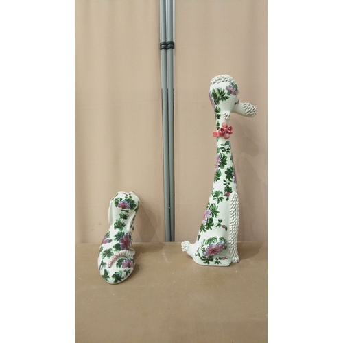 42 - Pair of ceramic dog figurines, hand-painted with floral motifs. Featuring intricate textures and vib... 